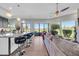 Inviting living room featuring bar seating, hardwood floors, and expansive views of the golf course at 7400 E Gainey Club Dr # 123, Scottsdale, AZ 85258