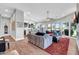 Bright, open living room with a view of the golf course, modern lighting, and wood-style flooring at 7400 E Gainey Club Dr # 123, Scottsdale, AZ 85258