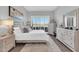 Serene main bedroom with golf course views, neutral tones, and luxury furnishings at 7400 E Gainey Club Dr # 123, Scottsdale, AZ 85258