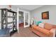 Cozy office space with a desk, orange sofa, and open doorway leading to the dining room at 7400 E Gainey Club Dr # 123, Scottsdale, AZ 85258