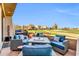 Relaxing patio area with comfortable seating, a fire pit, and picturesque golf course views at 7400 E Gainey Club Dr # 123, Scottsdale, AZ 85258