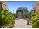 Charming courtyard with decorative stone paving and archway provides an inviting outdoor retreat at 7720 E Vaquero Dr, Scottsdale, AZ 85258