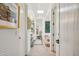 Hallway with stone floors, white walls, and decorative artwork at 7720 E Vaquero Dr, Scottsdale, AZ 85258