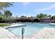 Inviting community pool featuring clear blue water, tiled sundeck, lounge chairs, and shaded seating areas at 7720 E Vaquero Dr, Scottsdale, AZ 85258