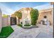 Backyard patio features a fountain, desert landscaping, a stainless steel grill, and a secure gate at 8401 N 84Th Pl, Scottsdale, AZ 85258