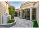 Courtyard featuring stone pavers, multiple sliding glass doors, and a tiled water feature at 8401 N 84Th Pl, Scottsdale, AZ 85258
