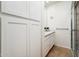 Well-lit bathroom with sleek white cabinetry, marble counters, and a glass-enclosed shower at 8401 N 84Th Pl, Scottsdale, AZ 85258