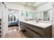 Open primary bathroom boasts a double sink vanity, stylish fixtures, modern lighting, and ensuite access to the primary suite at 8401 N 84Th Pl, Scottsdale, AZ 85258