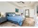 Spacious primary bedroom featuring neutral walls, travertine floors, stylish furniture, ensuite bathroom, and large mirror at 8401 N 84Th Pl, Scottsdale, AZ 85258