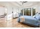 Bright bedroom with travertine flooring, a tray ceiling, large windows with backyard views, and chic modern furniture at 8401 N 84Th Pl, Scottsdale, AZ 85258
