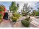 Community entrance featuring well-maintained landscaping, mature trees, and a clear view of tennis courts at 8401 N 84Th Pl, Scottsdale, AZ 85258