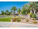 Welcoming community entrance with well-maintained landscaping, mature palm trees, and an elegant community sign at 8401 N 84Th Pl, Scottsdale, AZ 85258