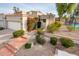 Charming home exterior featuring desert landscaping, a secure gated entrance, and a two car garage at 8401 N 84Th Pl, Scottsdale, AZ 85258