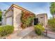 Southwestern home displaying a two-car garage, desert landscaping, and vibrant flowering vines at the entrance at 8401 N 84Th Pl, Scottsdale, AZ 85258