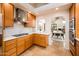 Stunning kitchen with custom wood cabinets, modern appliances, and pass through window to the dining area at 8401 N 84Th Pl, Scottsdale, AZ 85258