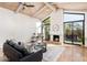Comfortable living room with stone fireplace, wood beam ceiling, modern furniture, and lots of natural light at 8401 N 84Th Pl, Scottsdale, AZ 85258