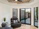 A well-lit living room features a vaulted wood ceiling, travertine floors, plush furniture, and access to the backyard at 8401 N 84Th Pl, Scottsdale, AZ 85258