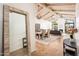Open concept living room featuring wood beam ceiling, dining area, fireplace, and modern finishes at 8401 N 84Th Pl, Scottsdale, AZ 85258