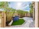 Inviting patio area with artificial turf, beautiful water feature, and mature landscaping at 8401 N 84Th Pl, Scottsdale, AZ 85258