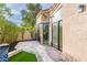 Tranquil patio area featuring lush landscaping, sliding glass doors, and elegant stone flooring at 8401 N 84Th Pl, Scottsdale, AZ 85258