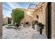 Inviting patio featuring seating, a stainless steel grill, lush greenery, custom shade structure, and decorative tile accents at 8401 N 84Th Pl, Scottsdale, AZ 85258
