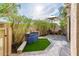 Charming backyard patio featuring outdoor dining set, artificial turf, water feature, and mature trees at 8401 N 84Th Pl, Scottsdale, AZ 85258