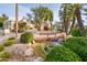 Beautiful water feature with small waterfall surrounded by lush landscaping and seating at 8401 N 84Th Pl, Scottsdale, AZ 85258