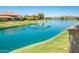 Scenic view of the lake with a fountain, lush greenery, and beautiful homes in the backdrop under a clear sky at 8401 N 84Th Pl, Scottsdale, AZ 85258