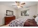 Comfortable main bedroom features soft lighting, a dresser, mirror and a window at 9202 N 107Th Ave, Sun City, AZ 85351