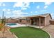 Inviting backyard with a pool, covered patio, and manicured lawn at 9306 E Fairbrook St, Mesa, AZ 85207
