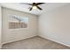 Bedroom with carpet flooring, a ceiling fan, and window at 9306 E Fairbrook St, Mesa, AZ 85207