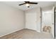 Neutral bedroom features carpet, a ceiling fan, and a closet with sliding doors at 9306 E Fairbrook St, Mesa, AZ 85207