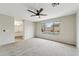 Main bedroom with carpet, large window, and an ensuite bathroom at 9306 E Fairbrook St, Mesa, AZ 85207