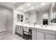 Bright bathroom vanity with gray cabinets, white countertop, double sinks and large mirror at 9462 W Weeping Willow Rd, Peoria, AZ 85383