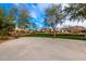 Community basketball court surrounded by mature trees and landscaping, offering a recreational space for residents at 9544 E Theia Dr, Mesa, AZ 85212