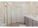 Bright bathroom with a glass shower, tiled floor, and grey vanity with white countertop at 9544 E Theia Dr, Mesa, AZ 85212