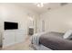 Comfortable bedroom with bed, ceiling fan, dresser and TV at 9544 E Theia Dr, Mesa, AZ 85212