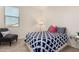 Well-lit bedroom featuring a patterned duvet and a large window at 9544 E Theia Dr, Mesa, AZ 85212