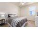 Cozy bedroom with a queen bed, side table, lamp, and a white ceiling fan at 9544 E Theia Dr, Mesa, AZ 85212