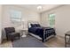 Cozy bedroom featuring a metal bed frame, ceiling fan, and neutral-colored walls at 9544 E Theia Dr, Mesa, AZ 85212