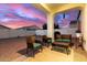 Relaxing covered patio with seating area and lush, low-maintenance landscaping at 9544 E Theia Dr, Mesa, AZ 85212