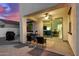 Inviting covered patio features comfortable seating and a ceiling fan, perfect for enjoying the outdoors at 9544 E Theia Dr, Mesa, AZ 85212