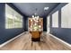 Stylish dining room features a modern light fixture, a large table, and a decorative wooden hutch at 9544 E Theia Dr, Mesa, AZ 85212