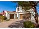 Lovely two-story home with a brick driveway and a three-car garage at 9544 E Theia Dr, Mesa, AZ 85212