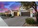 Lovely two-story home with a brick driveway and a three-car garage at 9544 E Theia Dr, Mesa, AZ 85212