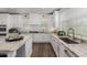 Well-lit kitchen showcases white cabinetry, granite countertops, and a sleek faucet at 9544 E Theia Dr, Mesa, AZ 85212