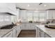Charming kitchen featuring stainless steel appliances, white cabinets, and granite countertops at 9544 E Theia Dr, Mesa, AZ 85212
