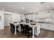 Bright kitchen features an oversized island with white cabinets and modern appliances at 9544 E Theia Dr, Mesa, AZ 85212