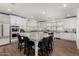 Spacious kitchen with a large center island featuring stone countertops and seating for six at 9544 E Theia Dr, Mesa, AZ 85212