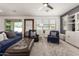 Inviting living room with comfortable seating, stylish decor, ceiling fan, and lots of natural light at 9544 E Theia Dr, Mesa, AZ 85212